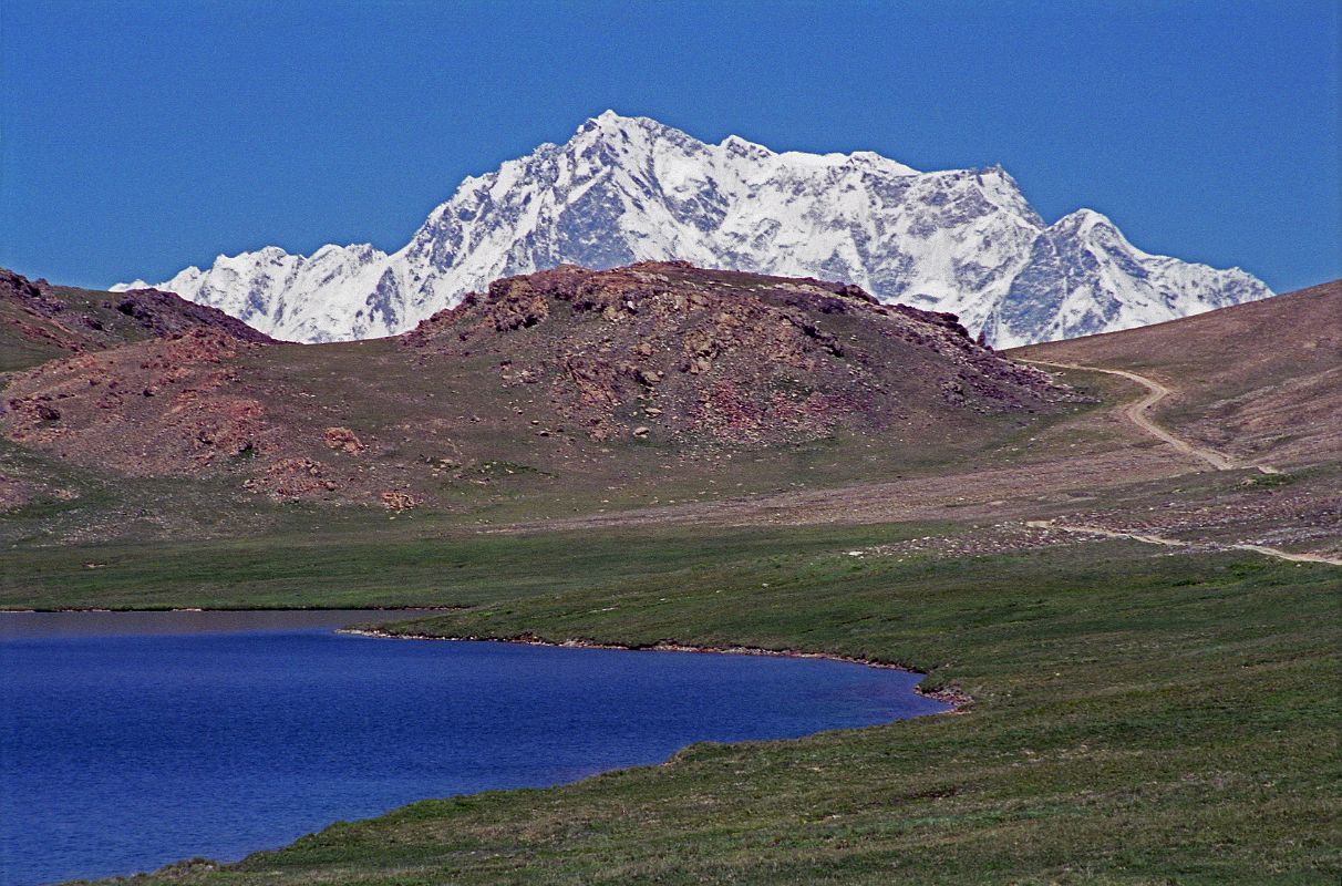 04 Nanga Parbat Rupal Face Above Sheosar Lake On The Deosai Plains We came over a hill and there in front of Sheosar Lake on the Deosai Plains was the Rupal face of Nanga Parbat. The mountain stands alone on the horizon, shining brilliantly white in the sunshine.